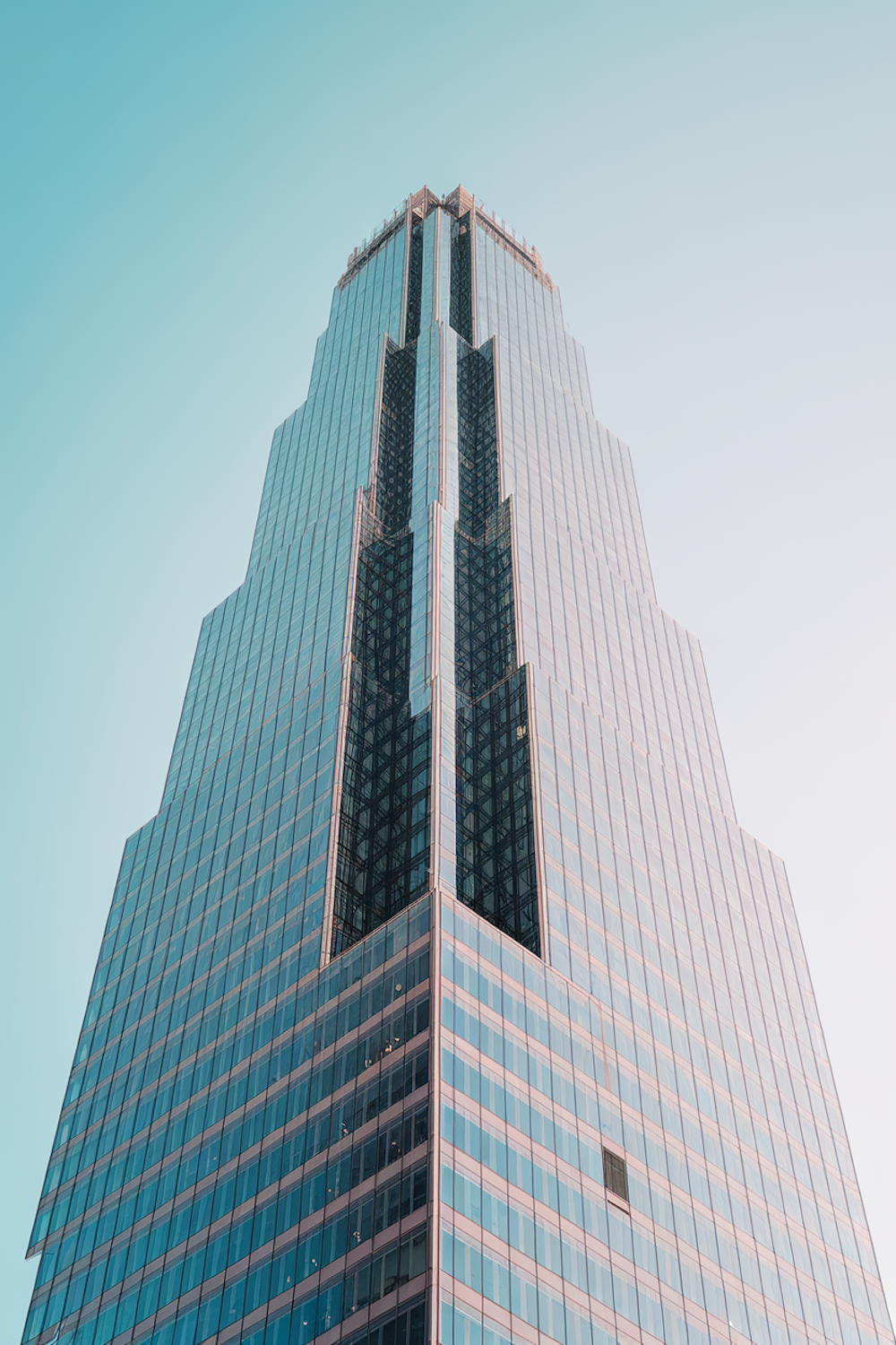 Steel-frame building under construction, structural members visible against sky